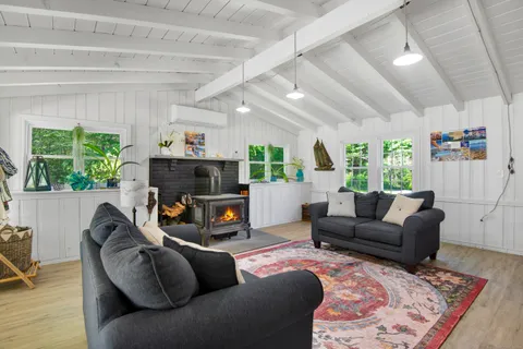 a living room with furniture a window and a flat screen tv