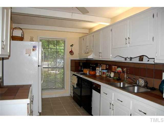 1339 Springlawn Court Raleigh, NC 27609 - Photo 8 of 17 a kitchen with refrigerator and cabinets