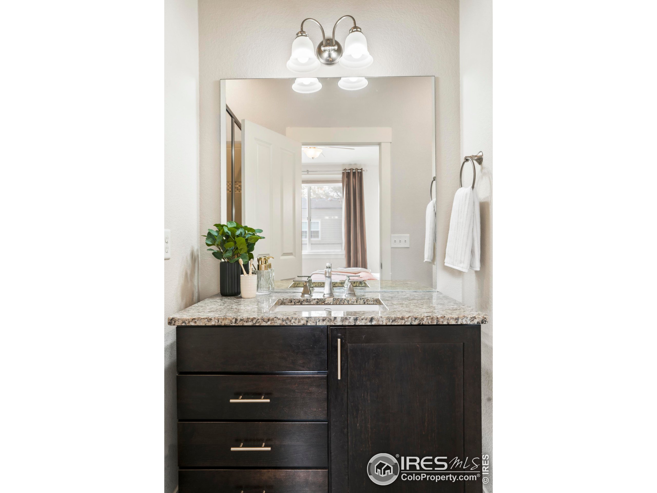 409 Terry Street, Unit B Longmont, CO 80501 - Photo 13 of 31 a bathroom with a sink and a mirror