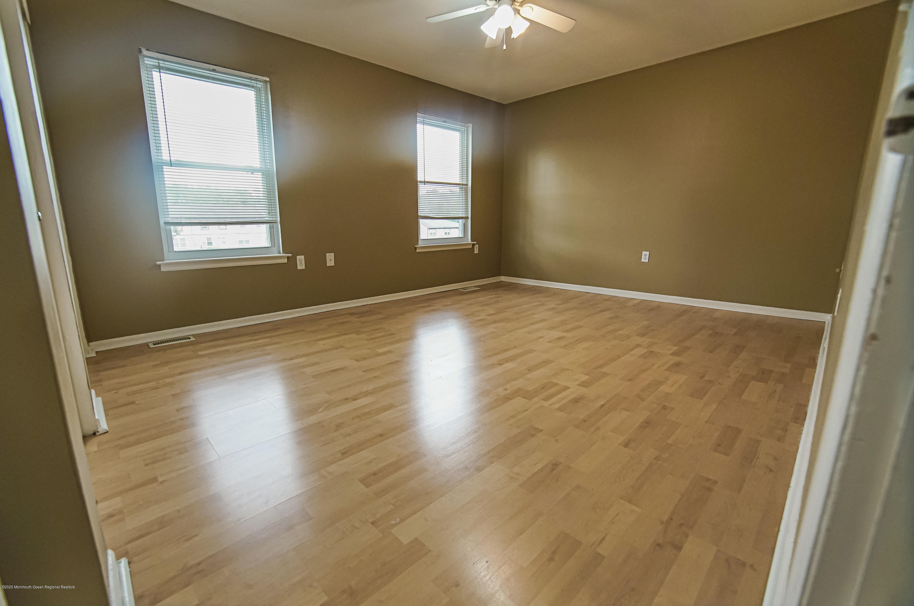 324 Greenwood Loop Road Brick, NJ 08724 - Photo 11 of 21 an empty room with wooden floor and windows