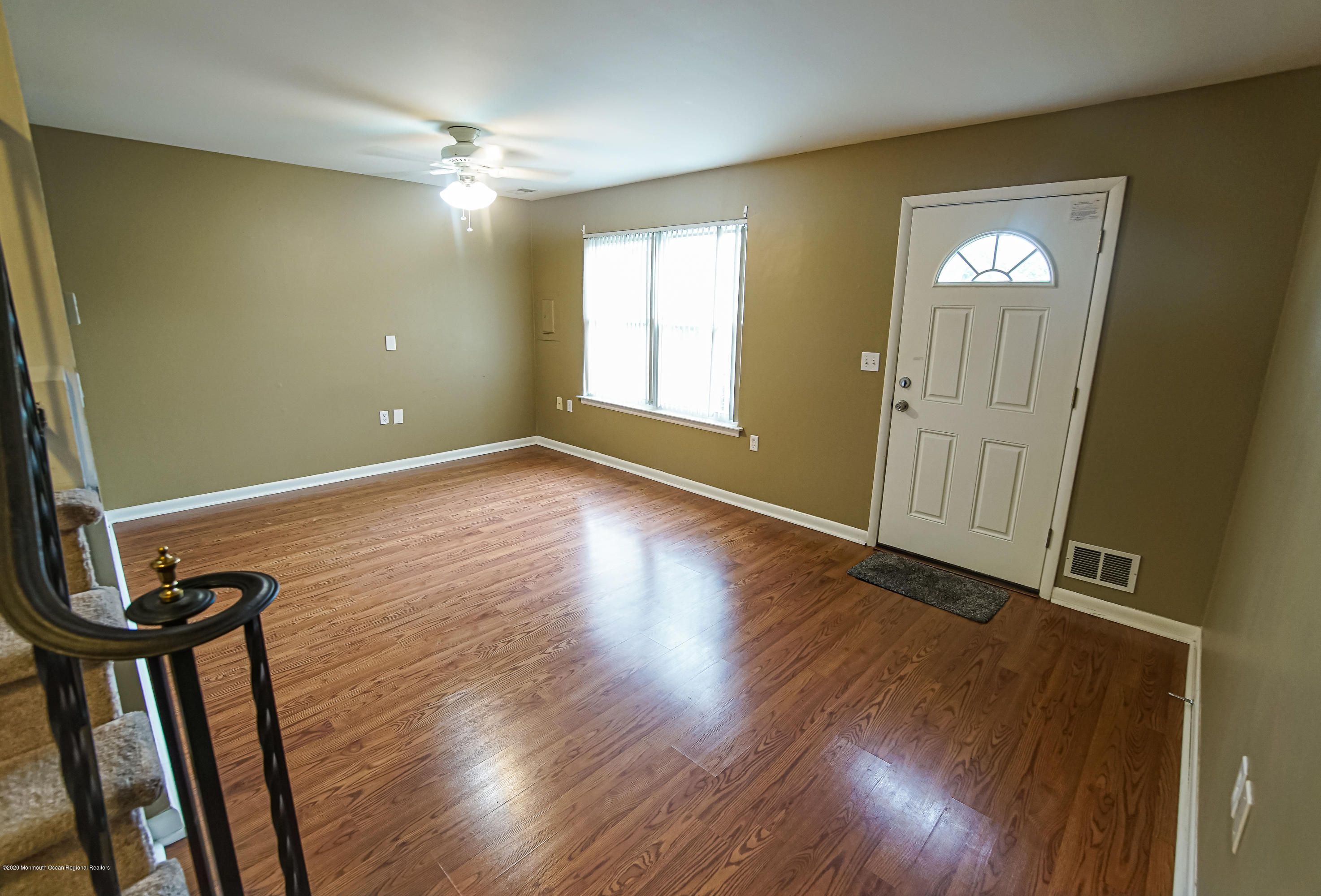 324 Greenwood Loop Road Brick, NJ 08724 - Photo 3 of 21 an empty room with wooden floor and windows