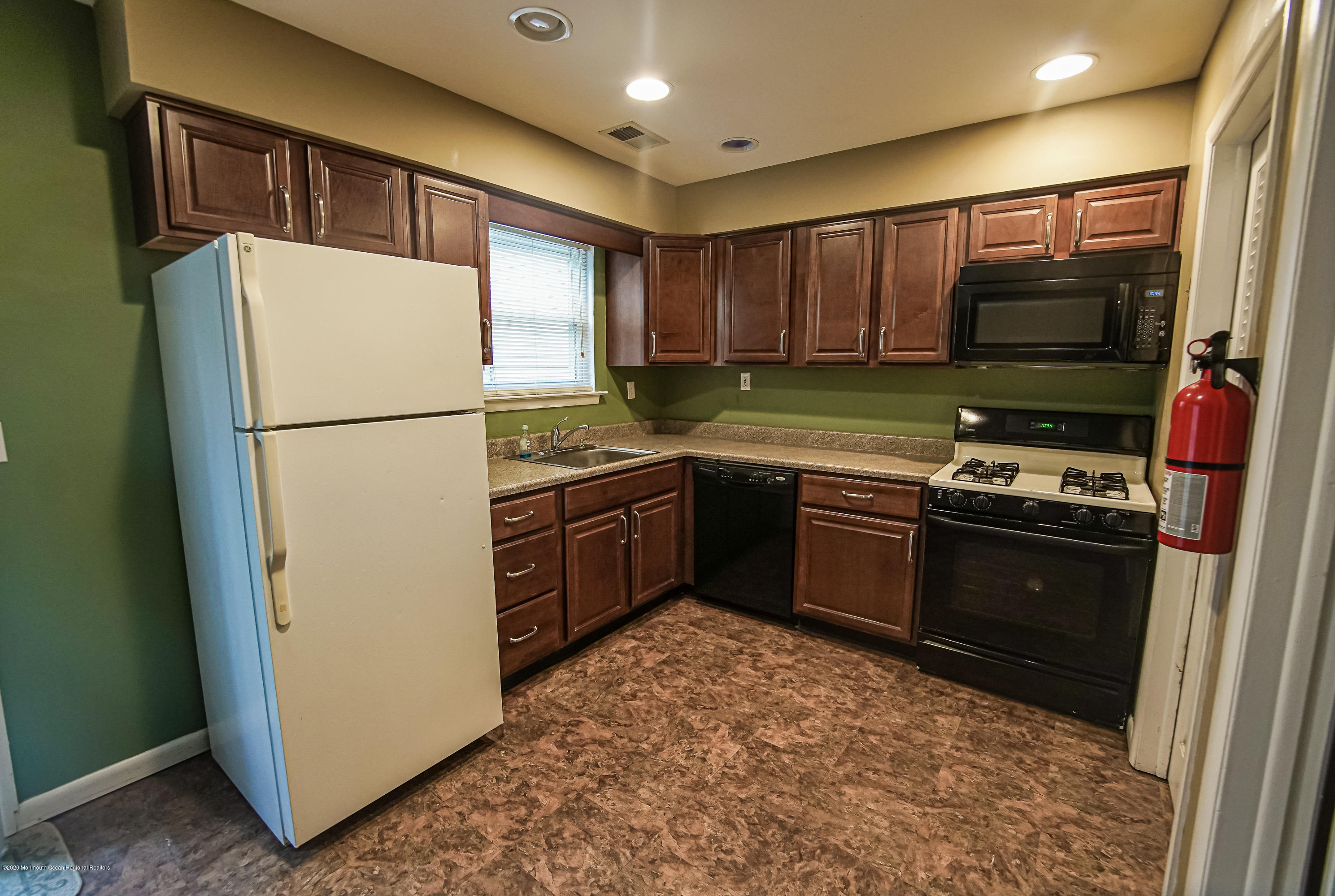 324 Greenwood Loop Road Brick, NJ 08724 - Photo 8 of 21 a kitchen with stainless steel appliances granite countertop a refrigerator a stove a sink and a microwave