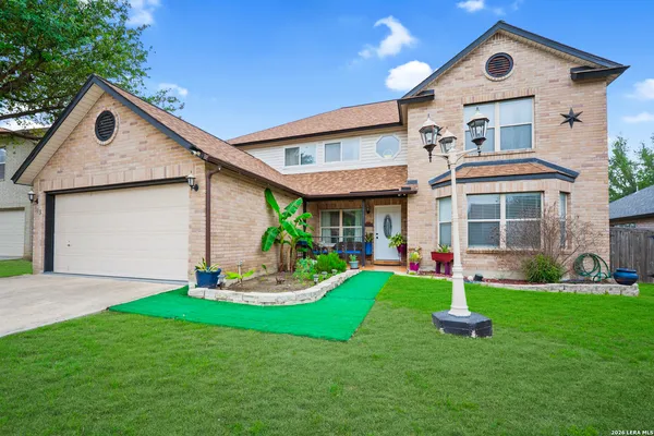 a front view of a house with a yard and garage