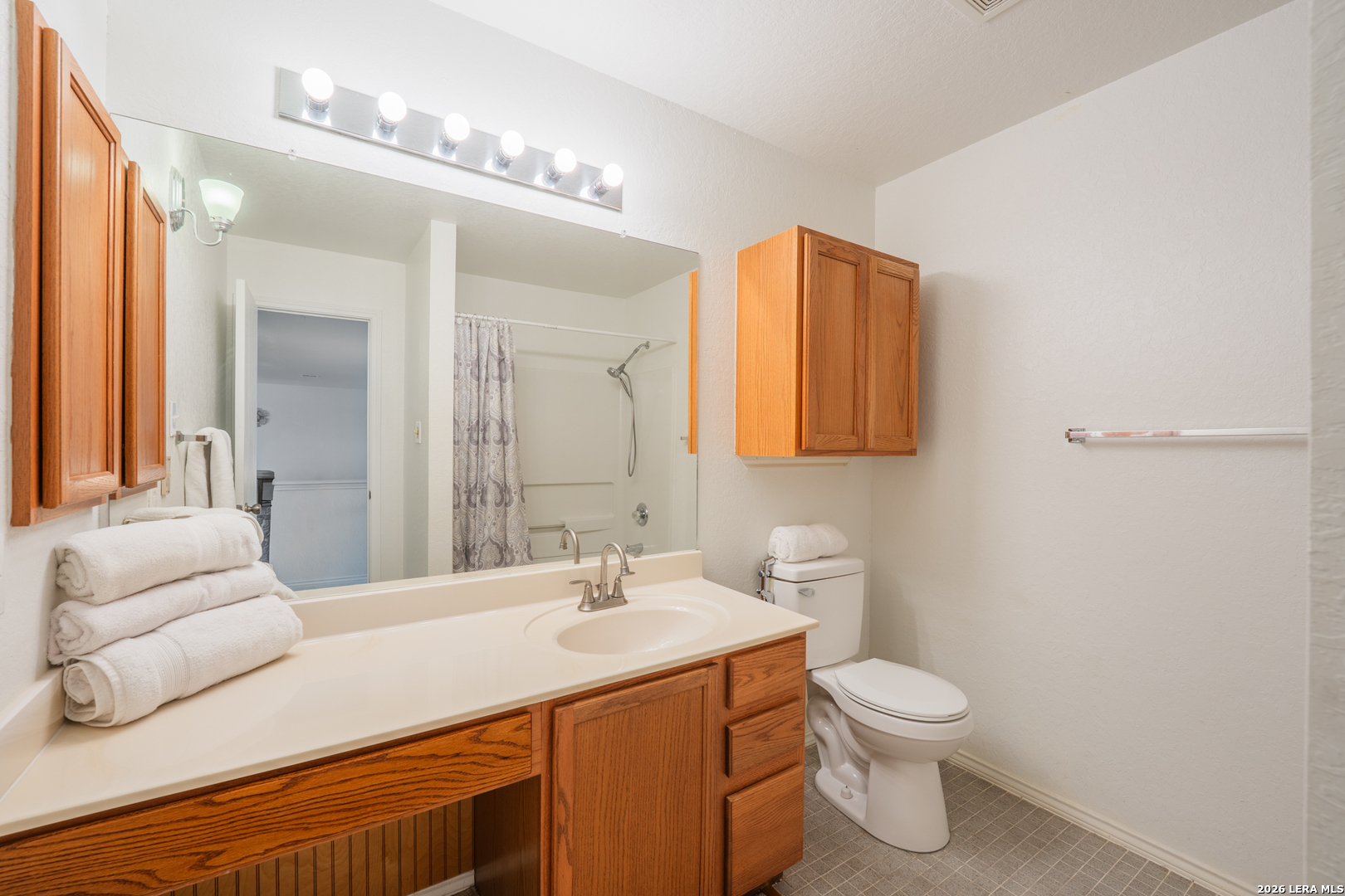 124 Springtree Grove Cibolo, TX 78108 - Photo 35 of 52 a bathroom with a toilet sink and mirror