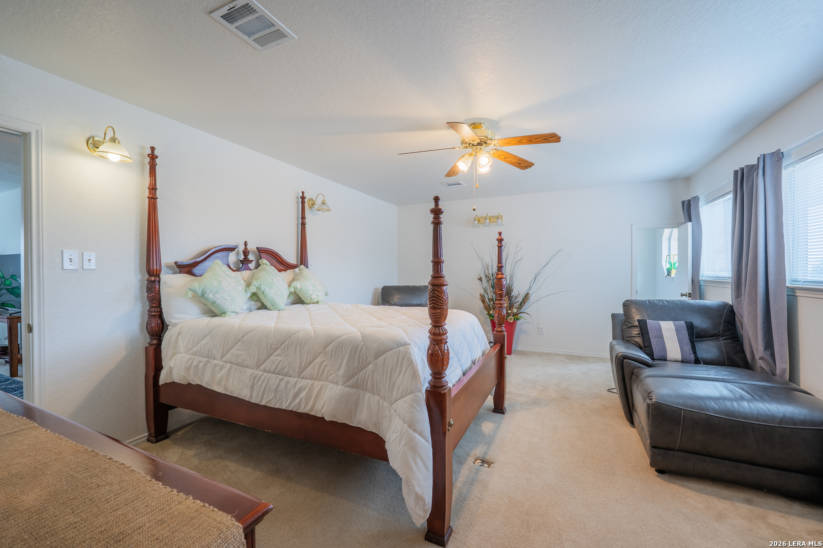124 Springtree Grove Cibolo, TX 78108 - Photo 36 of 52 a bedroom with a bed and a chandelier