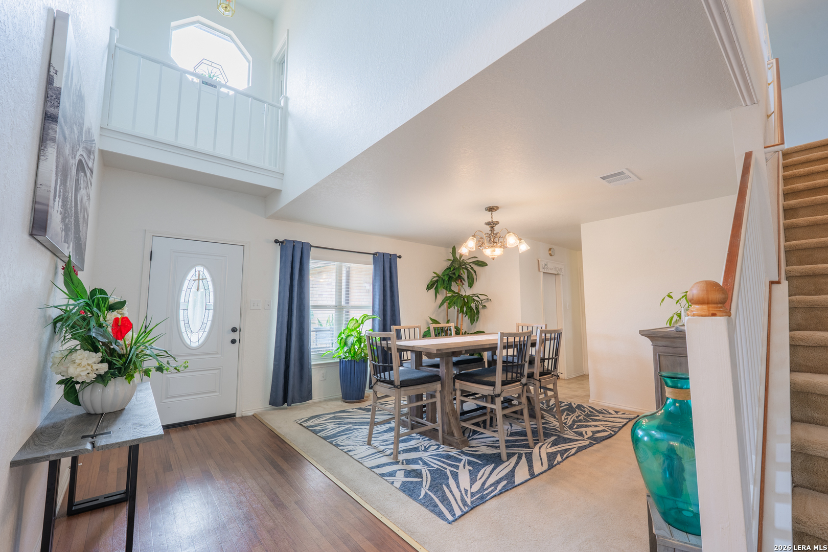 124 Springtree Grove Cibolo, TX 78108 - Photo 4 of 52 a dining room with furniture potted plants and wooden floor