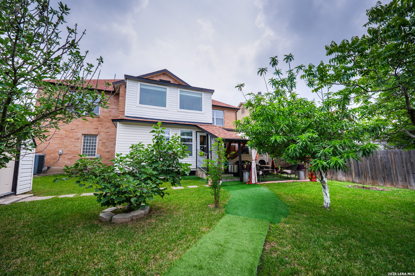 124 Springtree Grove Cibolo, TX 78108 - Photo 51 of 52 a view of a yard in front of a house with plants and large tree