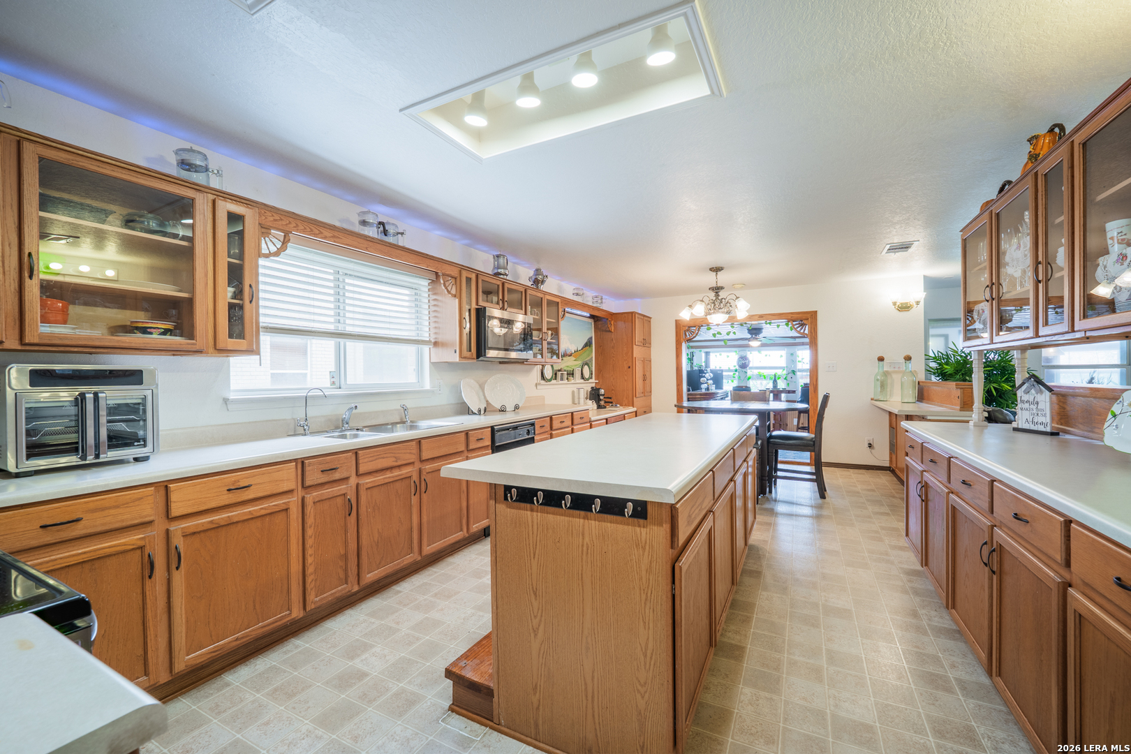 124 Springtree Grove Cibolo, TX 78108 - Photo 7 of 52 a kitchen with kitchen island a sink stove and cabinets
