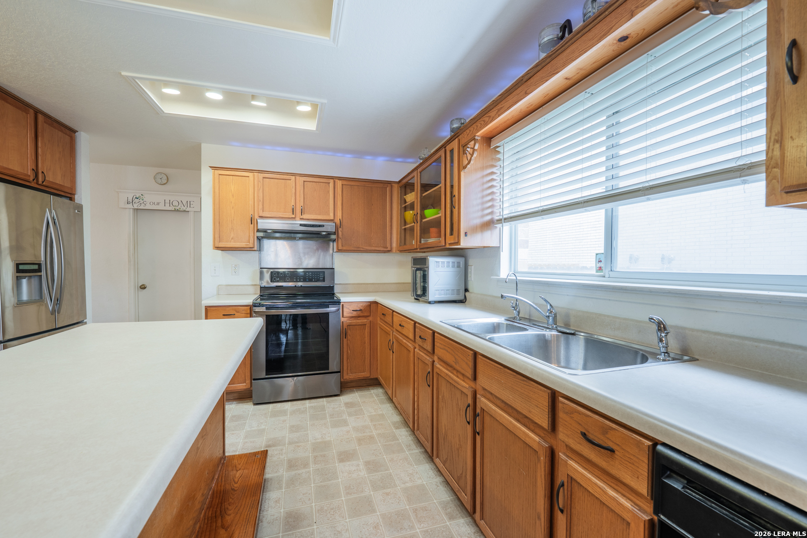 124 Springtree Grove Cibolo, TX 78108 - Photo 10 of 52 a kitchen with stainless steel appliances a stove sink and cabinets