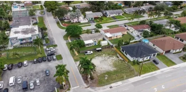 an aerial view of residential houses with outdoor space and street view