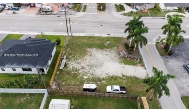 an aerial view of a house with a yard