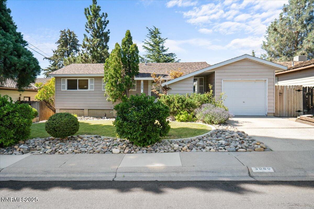 3080 Slater Avenue Reno, NV 89503 - Photo 1 of 17 a front view of a house with garage and plants