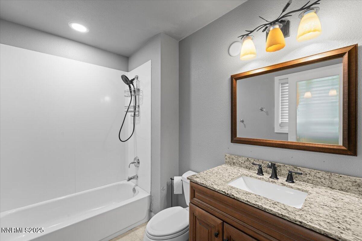3080 Slater Avenue Reno, NV 89503 - Photo 12 of 17 a bathroom with a granite countertop sink toilet and shower