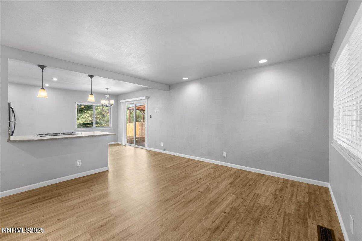3080 Slater Avenue Reno, NV 89503 - Photo 2 of 17 an empty room with wooden floor and windows