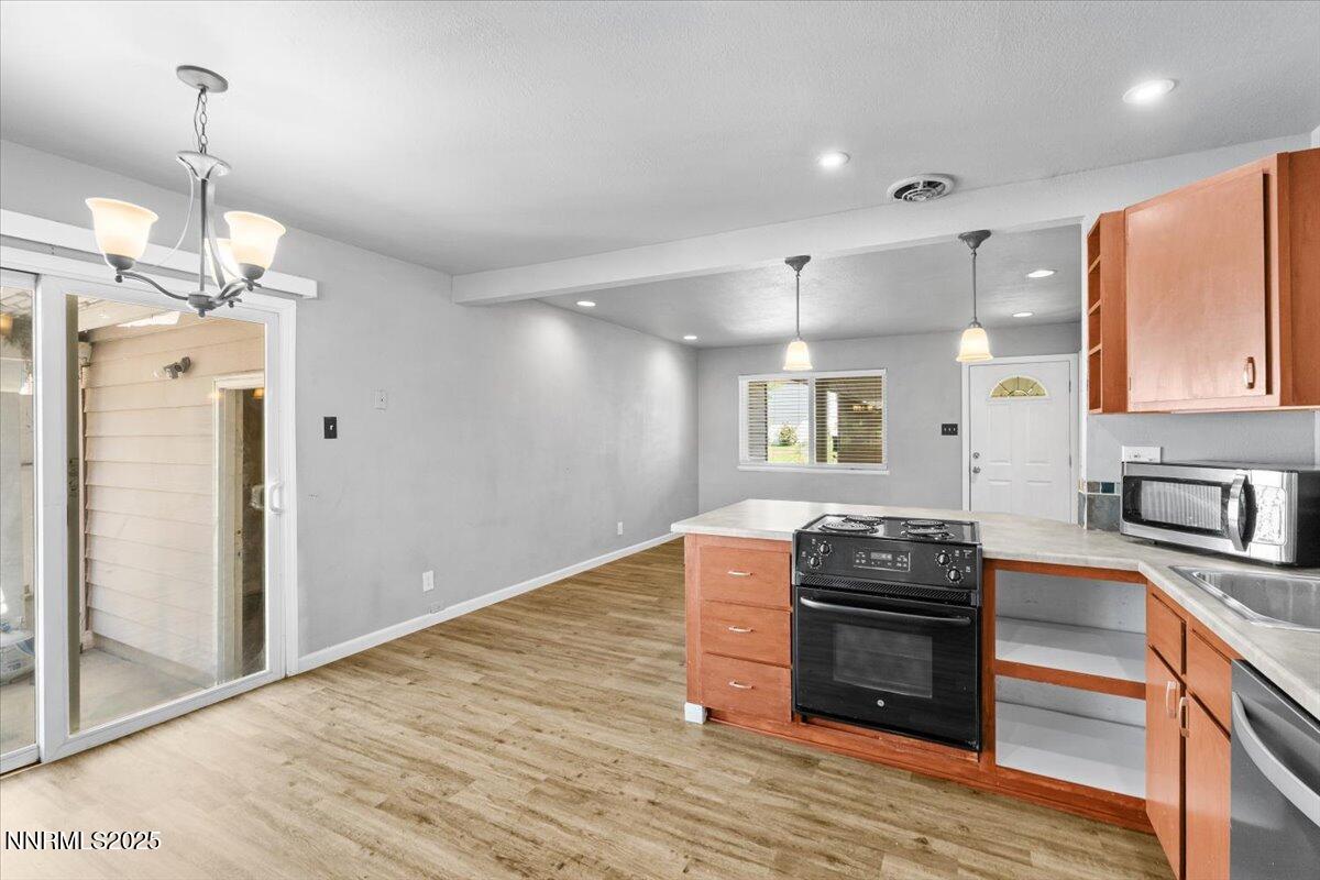 3080 Slater Avenue Reno, NV 89503 - Photo 8 of 17 a kitchen with granite countertop a stove and a wooden floors
