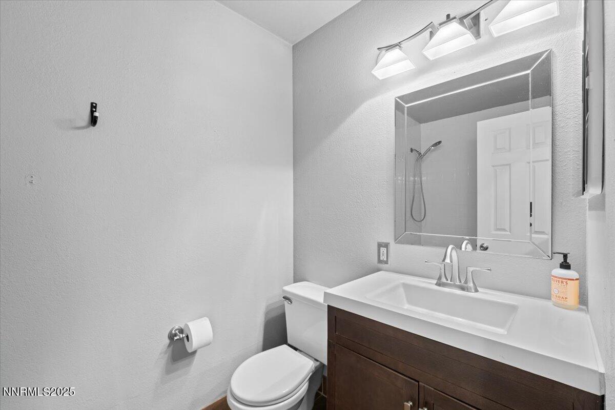 3080 Slater Avenue Reno, NV 89503 - Photo 9 of 17 a bathroom with a sink vanity mirror and toilet