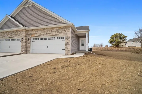 a view of garage with wooden fence