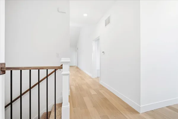 an empty room with a window and wooden floor