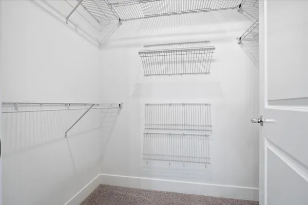 a spacious bathroom with a double vanity sink a toilet and a mirror