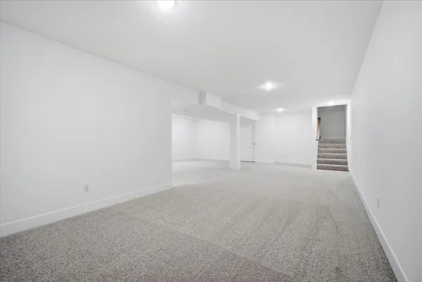an empty room with a empty space and windows