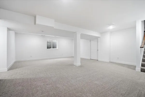 a view of a room with wooden floor and windows