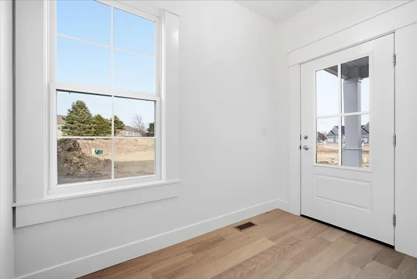a view of a hallway with wooden floor
