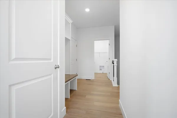 a large kitchen with cabinets wooden floor and stainless steel appliances