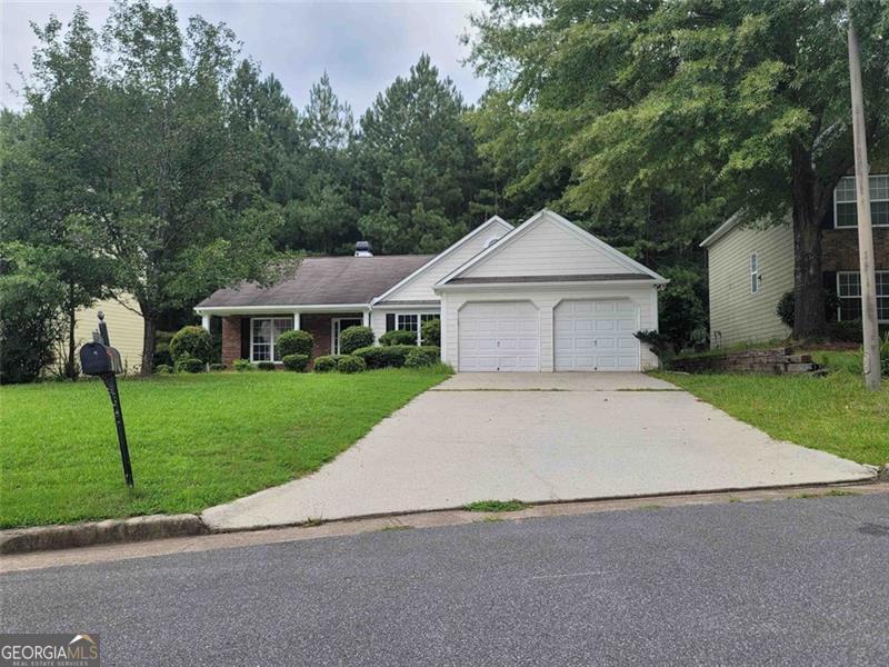 3014 Stirrup Lane Southwest Marietta, GA 30064 - Photo 1 of 10 a front view of a house with a yard and garage