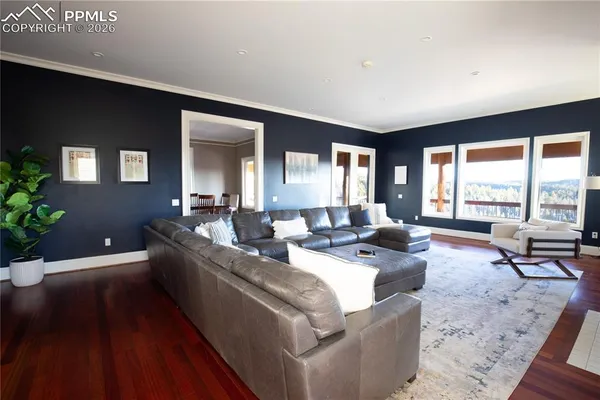 a living room with furniture and large windows