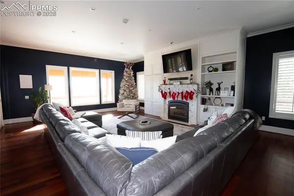a living room with fireplace furniture and a flat screen tv