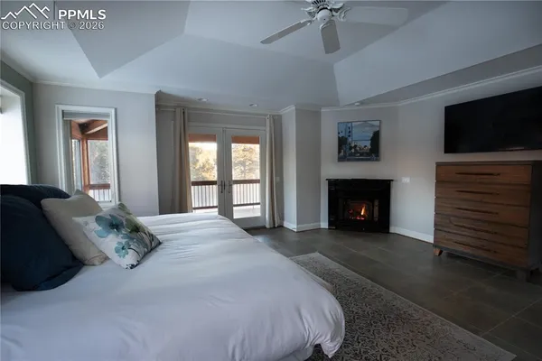 a spacious bedroom with a balcony a bed and a fireplace