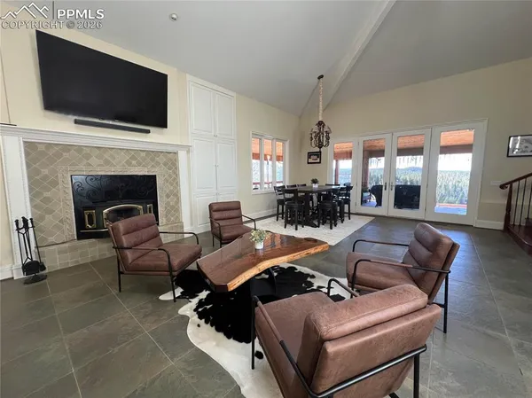 a living room with furniture a flat screen tv and a fireplace