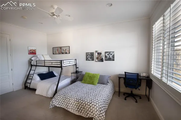 a bedroom with a bed chair and window