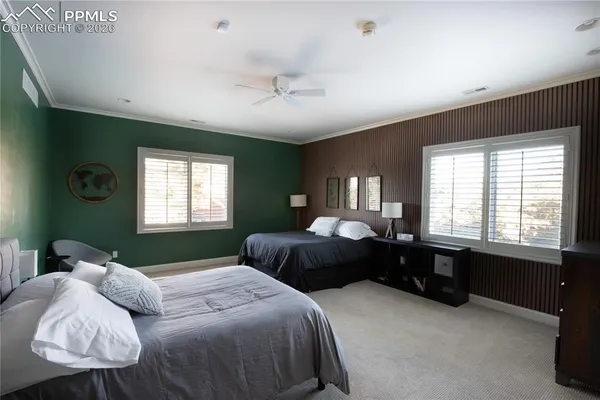 a bedroom with a bed wooden floor and window