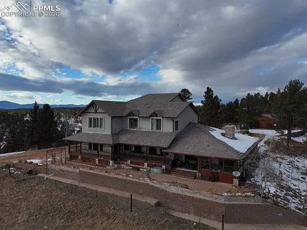 a aerial view of a house with a yard and sitting area
