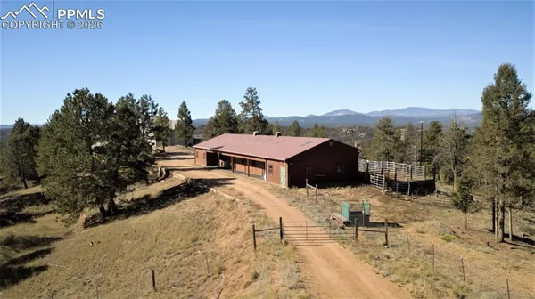 a view of a house with a yard covered in snow