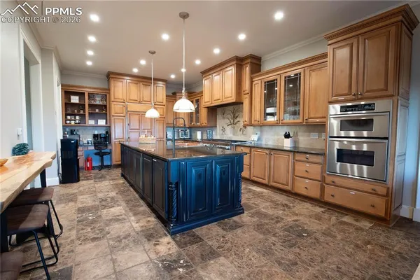 a kitchen with stainless steel appliances granite countertop a stove a sink and a refrigerator