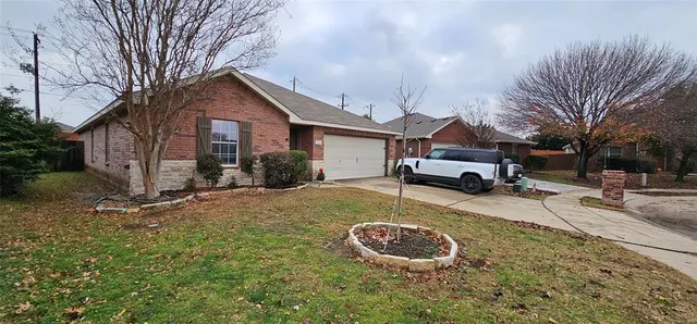 a view of a house with a yard covered in snow