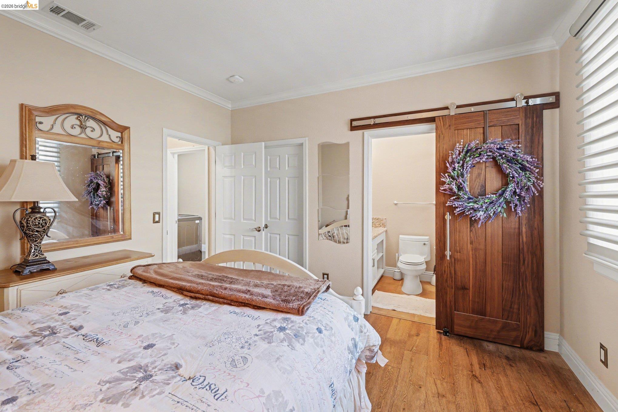 550 Rutherford Circle Brentwood, CA 94513 - Photo 13 of 28 Bedroom with light wood-style floors, crown molding, and ensuite bathroom