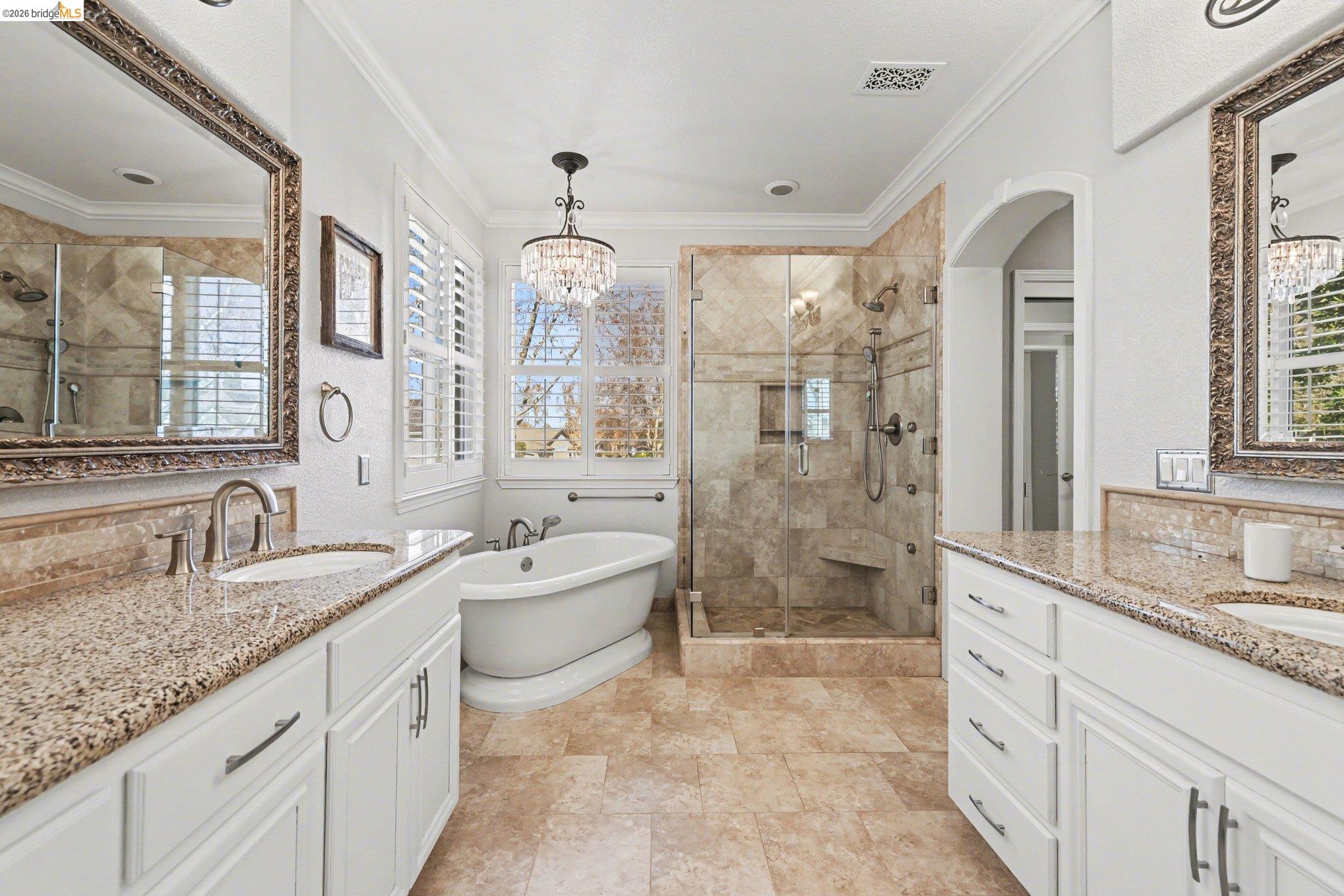 550 Rutherford Circle Brentwood, CA 94513 - Photo 15 of 28 Full bath with a shower stall, a freestanding tub, two vanities, crown molding, and suspended lighting