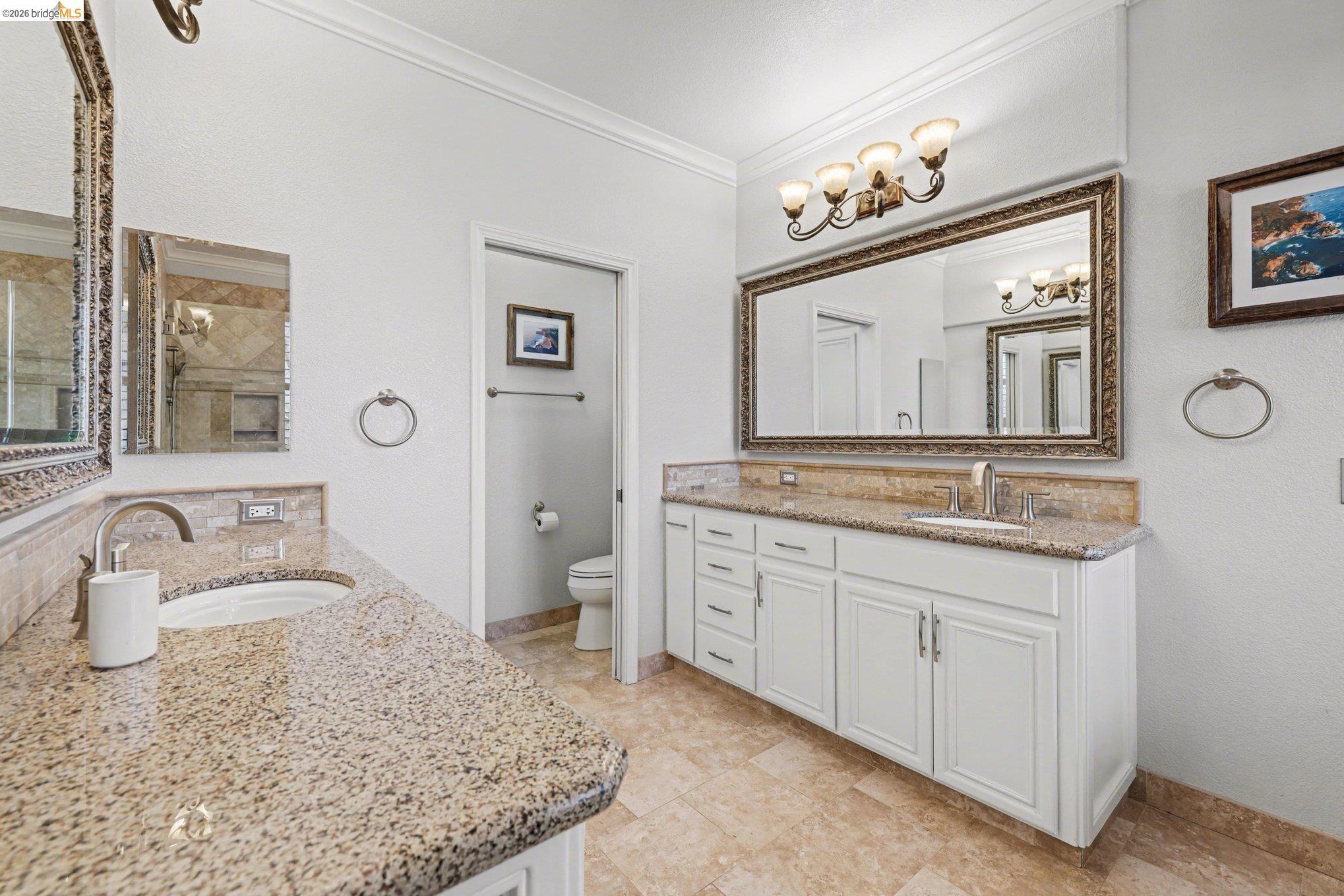 550 Rutherford Circle Brentwood, CA 94513 - Photo 16 of 28 Bathroom with two vanities, crown molding, and a textured wall
