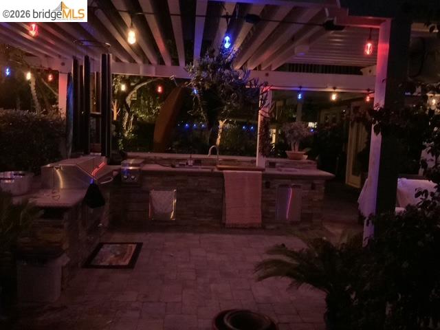 550 Rutherford Circle Brentwood, CA 94513 - Photo 26 of 28 Patio at night with an outdoor kitchen and a patio