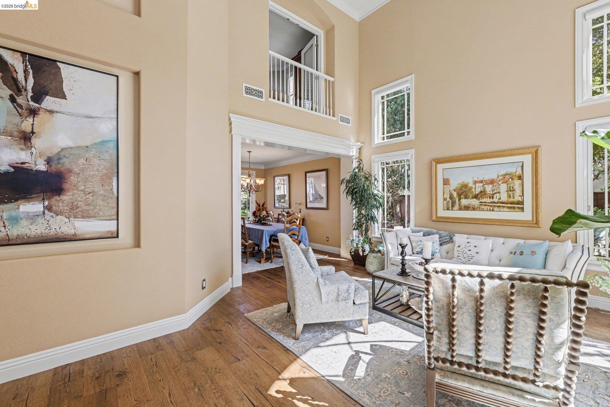 550 Rutherford Circle Brentwood, CA 94513 - Photo 4 of 28 Living area with crown molding, a high ceiling, hardwood / wood-style floors, a chandelier, and plenty of natural light
