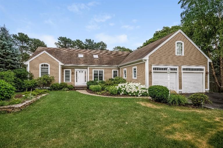 17 Meadowbrook Road Mashpee, MA 02649 - Photo 1 of 29 a front view of a house with a yard and garage