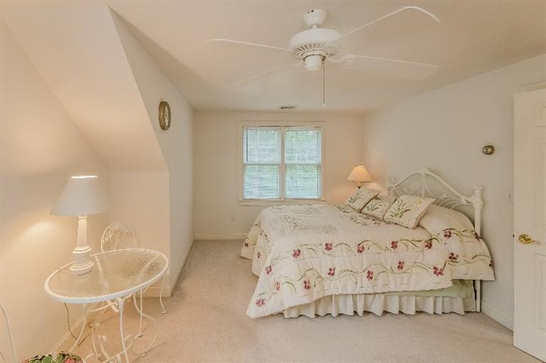 17 Meadowbrook Road Mashpee, MA 02649 - Photo 20 of 29 a bedroom with a bed and chandelier