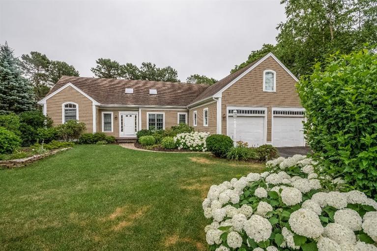 17 Meadowbrook Road Mashpee, MA 02649 - Photo 2 of 29 a front view of a house with a yard and a garden