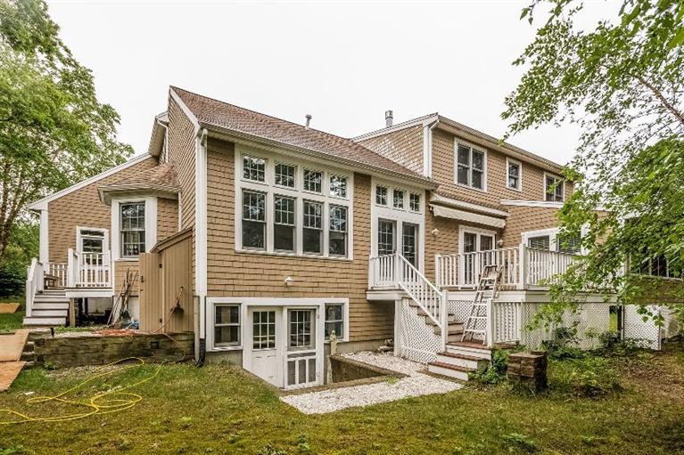 17 Meadowbrook Road Mashpee, MA 02649 - Photo 27 of 29 a front view of a house with a yard