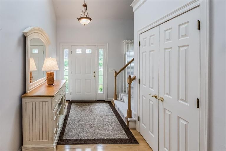 17 Meadowbrook Road Mashpee, MA 02649 - Photo 3 of 29 a view of a hallway with wooden floor and staircase