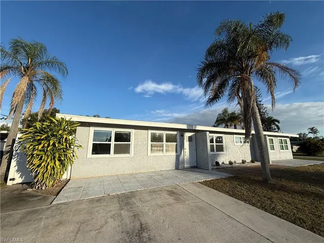 a house with a yard and a garage