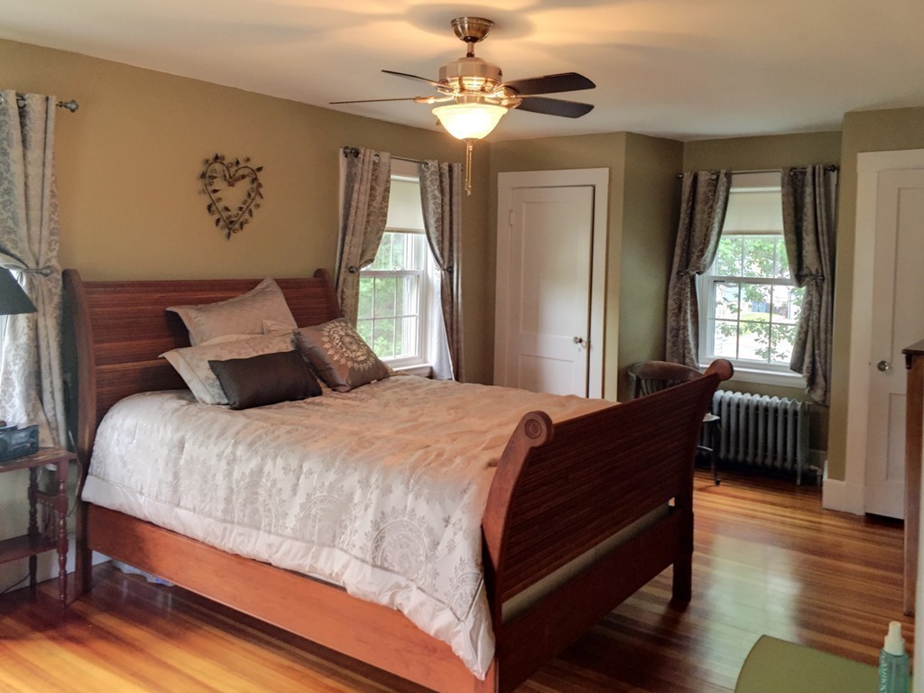 62 Edgehill Road Winthrop, MA 02152 - Photo 19 of 29 a bedroom with a bed wooden floor and window